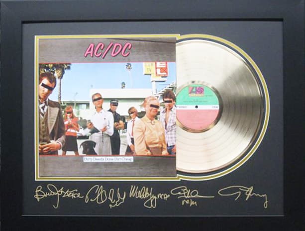 Framed gold record displayed beside the AC/DC album cover with a laser-reproduced signature, offered as a charity auction lot