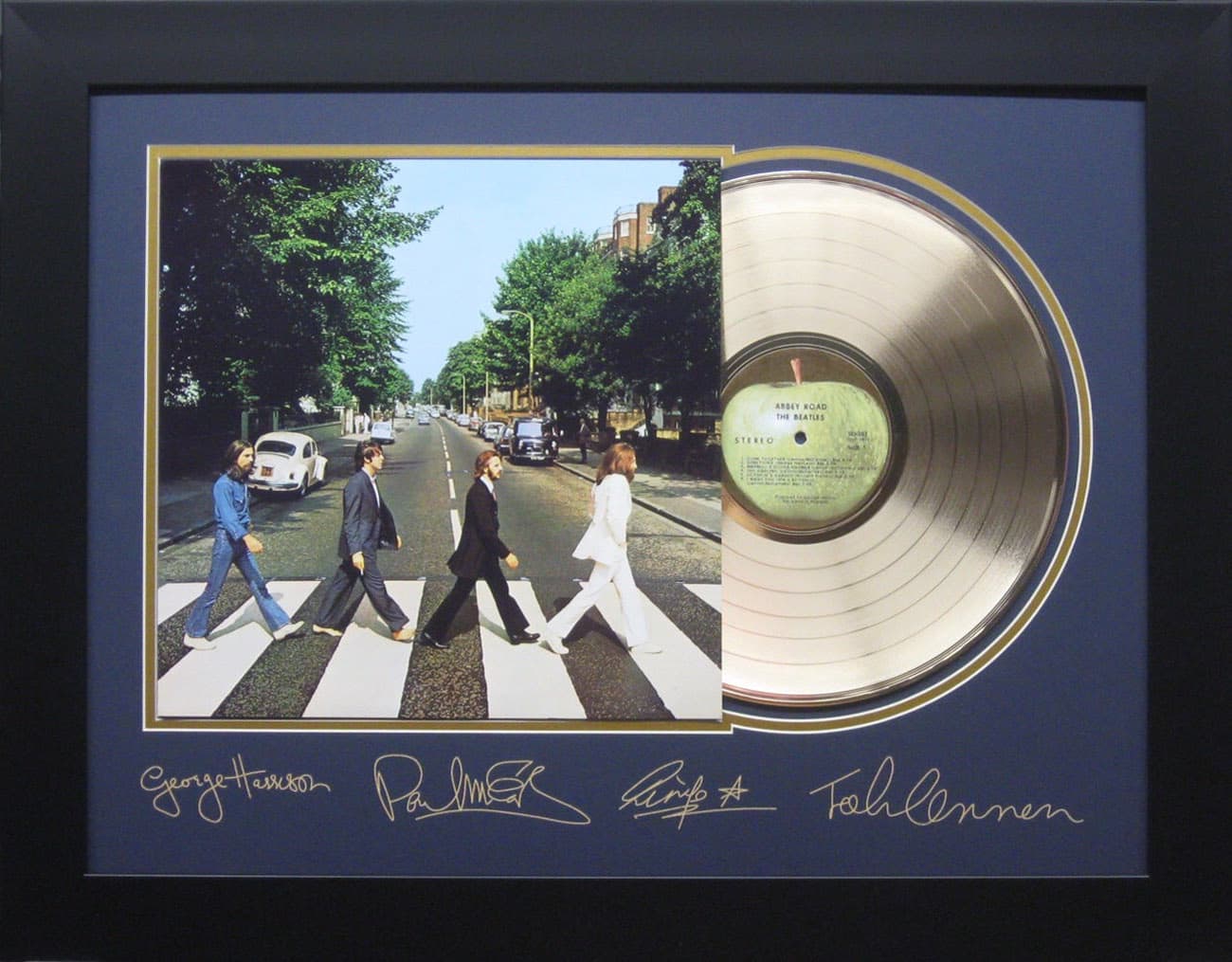 Framed gold record displayed beside the The Beatles Abbey Road album cover with a laser-reproduced signature, offered as a charity auction lot