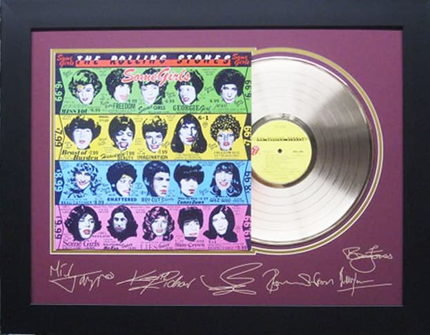Framed gold record displayed beside the The Rolling Stones Some Girls album cover with a laser-reproduced signature, offered as a charity auction lot