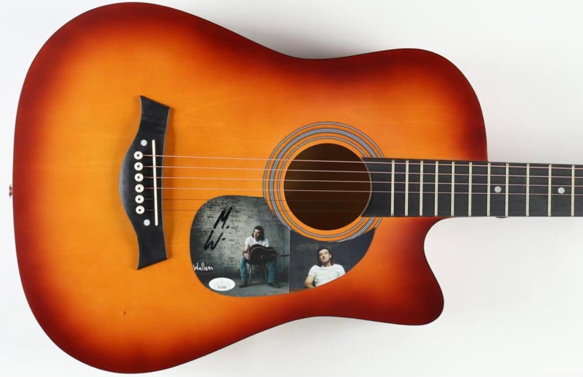 Sunburst acoustic guitar hand-signed by Morgan Wallen, the style of celebrity signed guitar offered as a fundraiser auction item